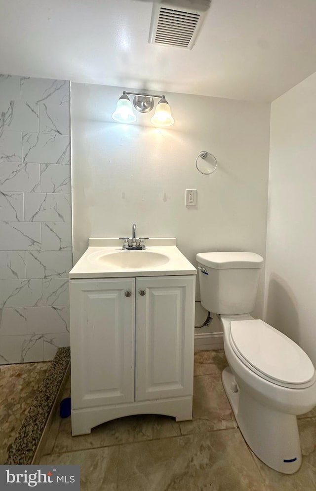 bathroom with toilet, visible vents, a shower, and vanity