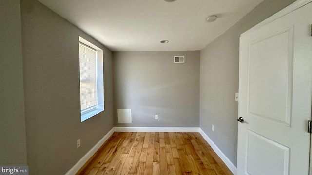 unfurnished room with baseboards, visible vents, and light wood-style flooring