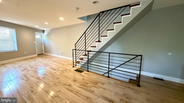 entryway featuring recessed lighting, baseboards, wood finished floors, and stairway