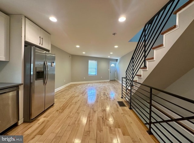 kitchen with visible vents, light wood-style floors, recessed lighting, white cabinets, and appliances with stainless steel finishes