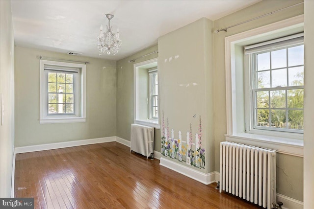 51 Cowpath Rd, Souderton, PA 18964 - empty room with an inviting chandelier, radiator heating unit, and hardwood / wood-style flooring