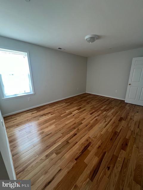 2287 Waterview Dr, Nanticoke, MD 21840 - empty room with baseboards, wood finished floors, and visible vents