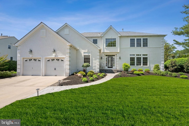 traditional-style house with stucco siding, driveway, a front lawn, and a garage