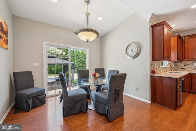 dining room featuring baseboards, recessed lighting, and wood finished floors