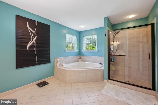 bathroom featuring tile patterned flooring, a stall shower, and a bath