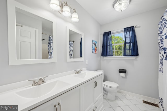 bathroom with visible vents, a sink, baseboards, and double vanity