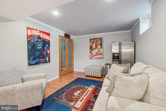 living room featuring french doors, baseboards, crown molding, and wood finished floors