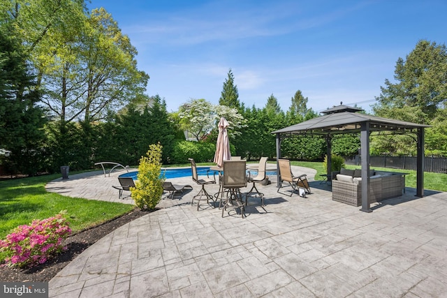 pool with a gazebo, outdoor lounge area, a patio area, and fence