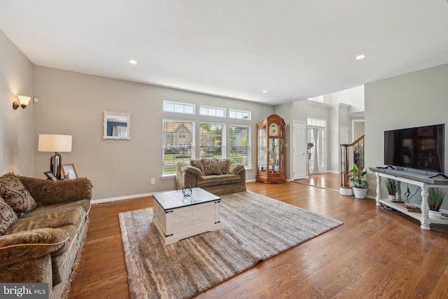 living room featuring baseboards, recessed lighting, and wood finished floors