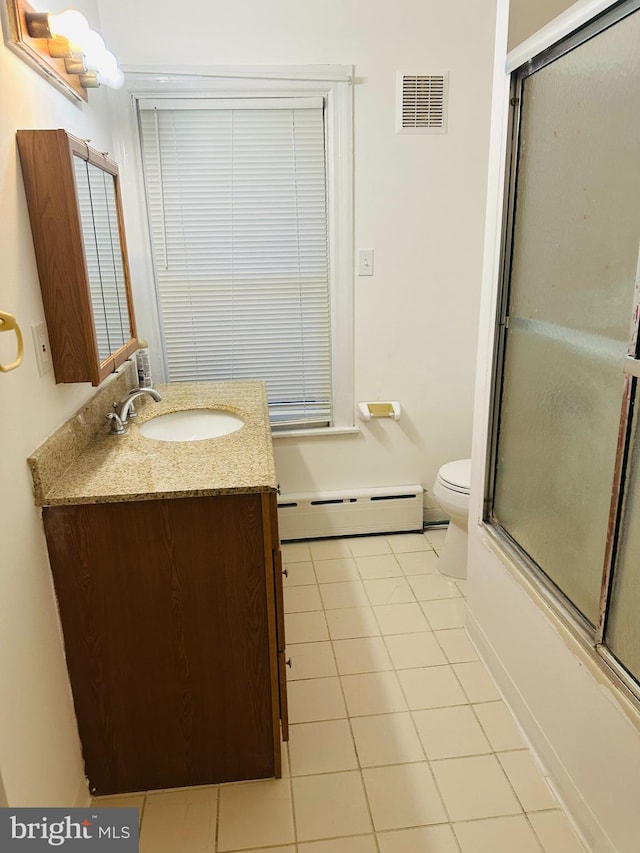 241 Ardmore Ave, Upper Darby, PA 19082 - full bathroom with visible vents, tile patterned flooring, vanity, a baseboard heating unit, and toilet