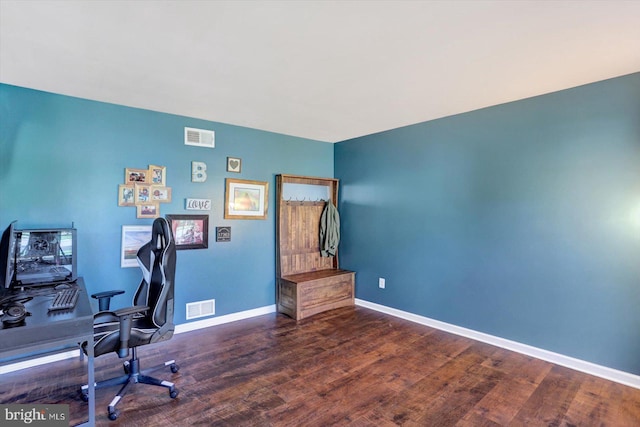 office featuring baseboards, wood finished floors, and visible vents