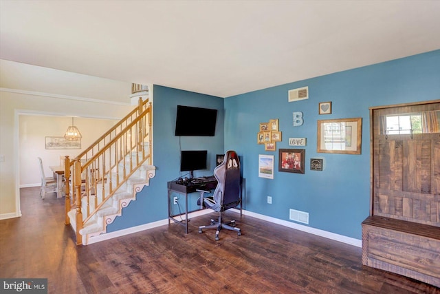 home office featuring a chandelier, baseboards, visible vents, and wood finished floors