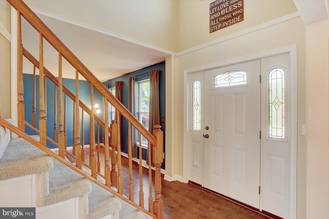 entrance foyer with baseboards, stairs, and wood finished floors
