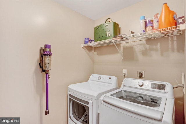 laundry area with separate washer and dryer and laundry area