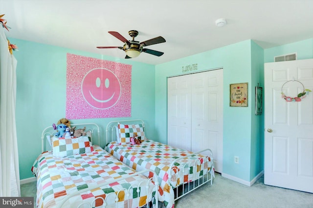 carpeted bedroom with visible vents, baseboards, ceiling fan, and a closet