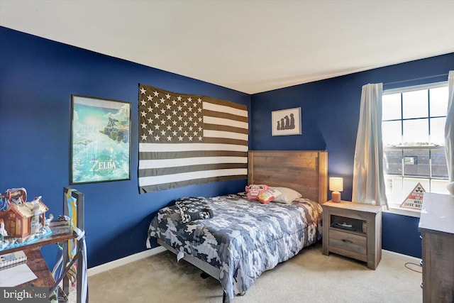 bedroom featuring baseboards and carpet