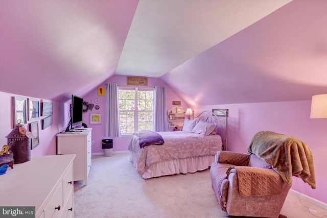 bedroom featuring baseboards, vaulted ceiling, and light carpet