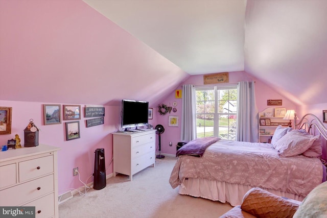bedroom featuring baseboards, light colored carpet, and vaulted ceiling