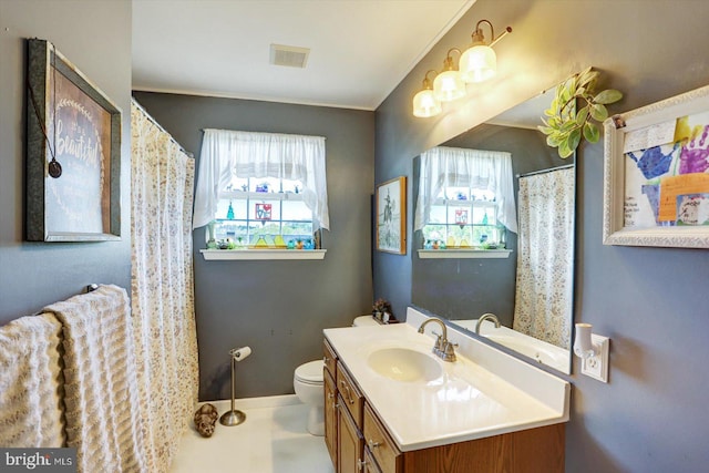 bathroom featuring vanity, baseboards, toilet, and visible vents