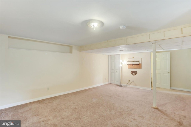 finished basement featuring baseboards and light colored carpet