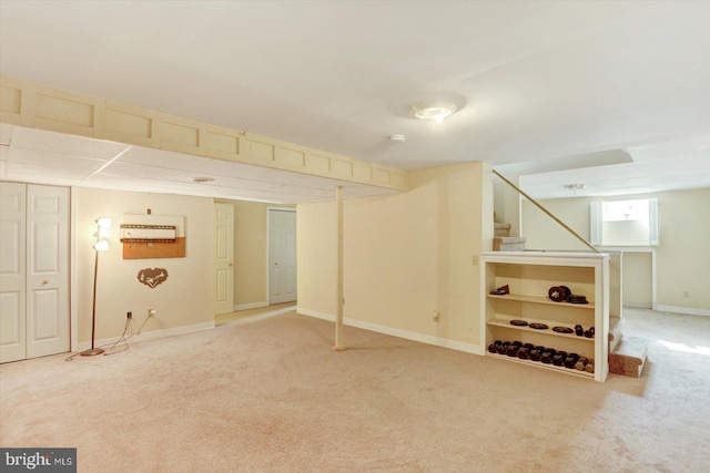 basement with stairway, baseboards, and carpet flooring