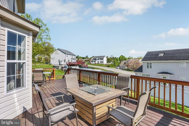wooden deck with a residential view and outdoor dining space