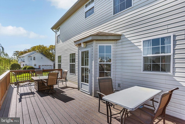 wooden deck featuring outdoor dining area