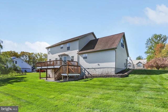 back of property with stairway, a yard, a wooden deck, and a shingled roof