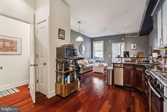 1519 Pine St Unit 7, Philadelphia, PA 19102 - kitchen with dark wood-type flooring, dark countertops, appliances with stainless steel finishes, and a peninsula