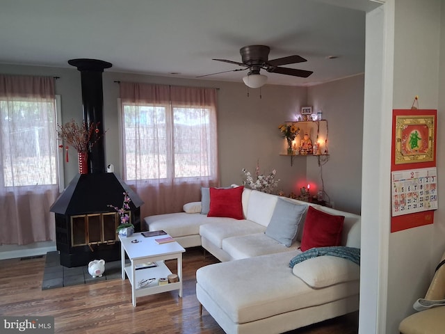 229 Old Line Ave, Laurel, MD 20724 - living area featuring a wood stove, ceiling fan, and wood finished floors