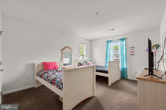 carpeted bedroom featuring visible vents and baseboards