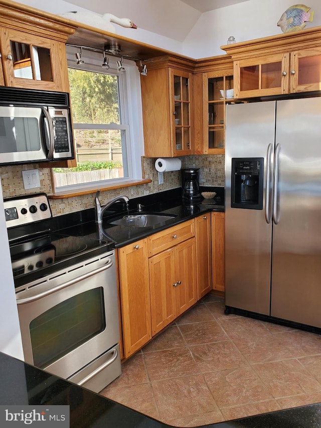 16254 Neabsco Beach Way, Woodbridge, VA 22191 - kitchen featuring brown cabinetry, decorative backsplash, and appliances with stainless steel finishes