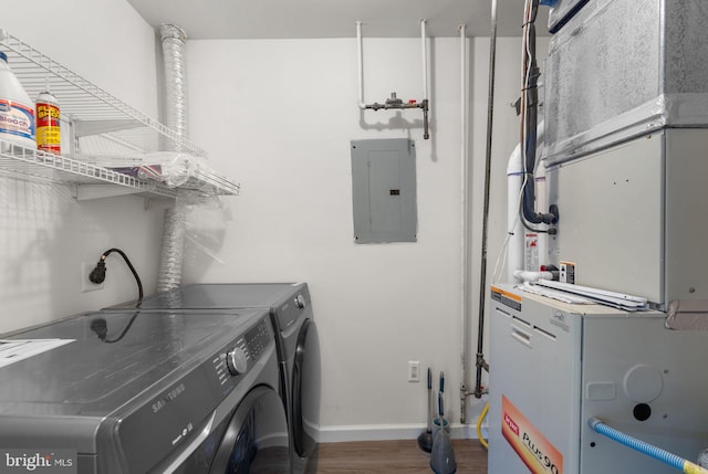 laundry area with heating unit, separate washer and dryer, laundry area, electric panel, and baseboards