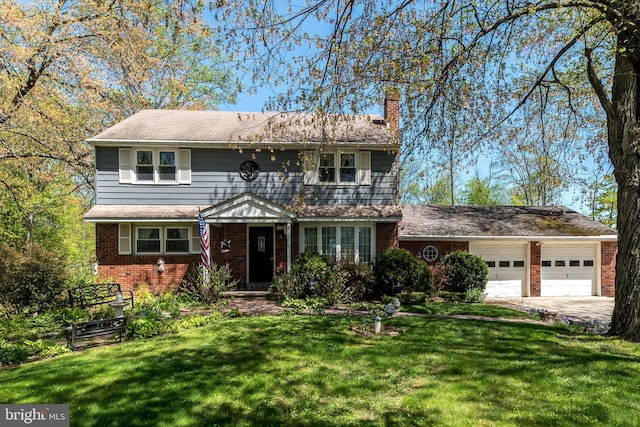 view of front of home with brick siding, a garage, a front yard, a chimney, and driveway