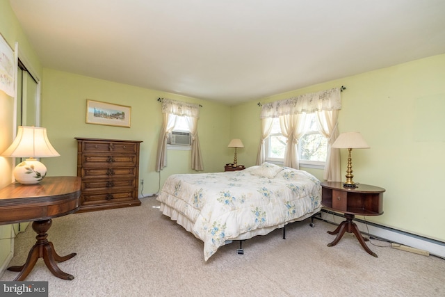 bedroom with carpet floors, multiple windows, a baseboard radiator, and cooling unit