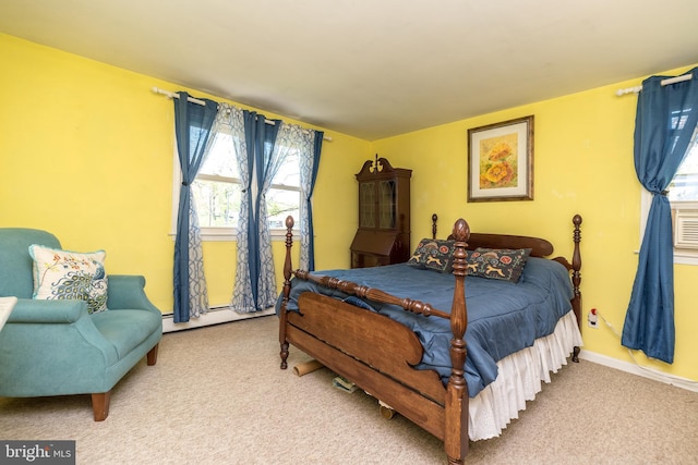 carpeted bedroom featuring baseboards and baseboard heating