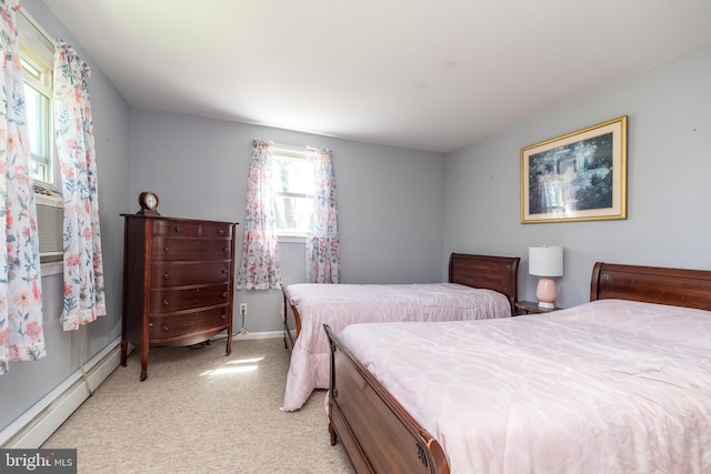 bedroom with light colored carpet, baseboards, and baseboard heating