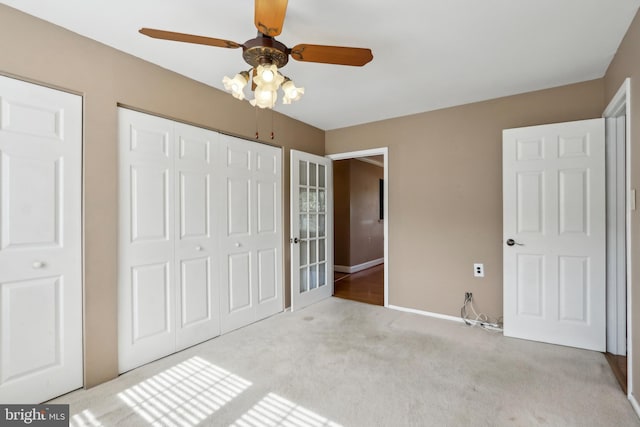 unfurnished bedroom featuring ceiling fan, baseboards, carpet flooring, and a closet