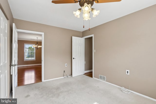 unfurnished bedroom with baseboards, visible vents, and carpet floors