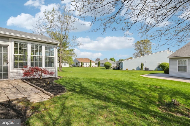view of yard with a residential view and a patio area