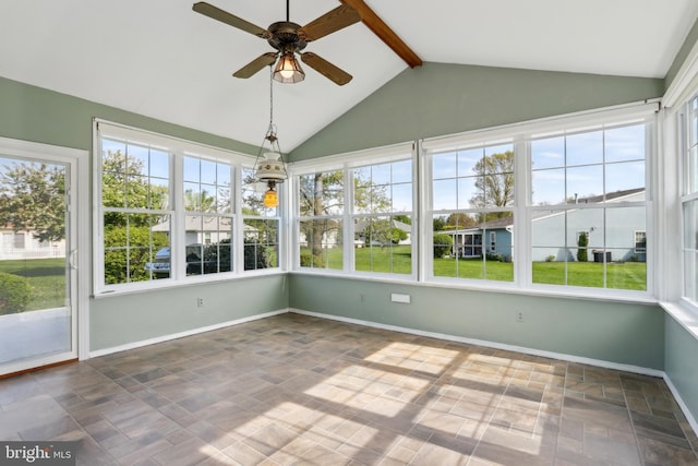 unfurnished sunroom with vaulted ceiling with beams and baseboards