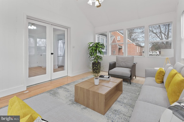 interior space with lofted ceiling, a ceiling fan, wood finished floors, and french doors