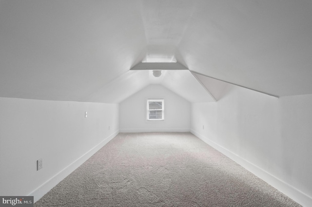 bonus room with baseboards, carpet, and lofted ceiling