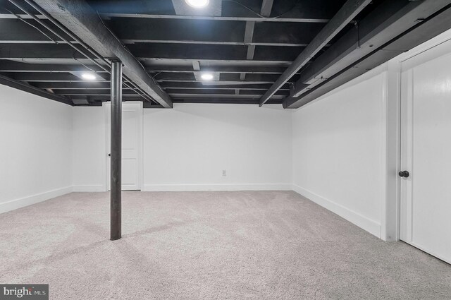 finished below grade area featuring carpet flooring and baseboards