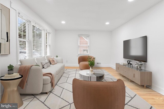 living area featuring recessed lighting, a wealth of natural light, and light wood finished floors