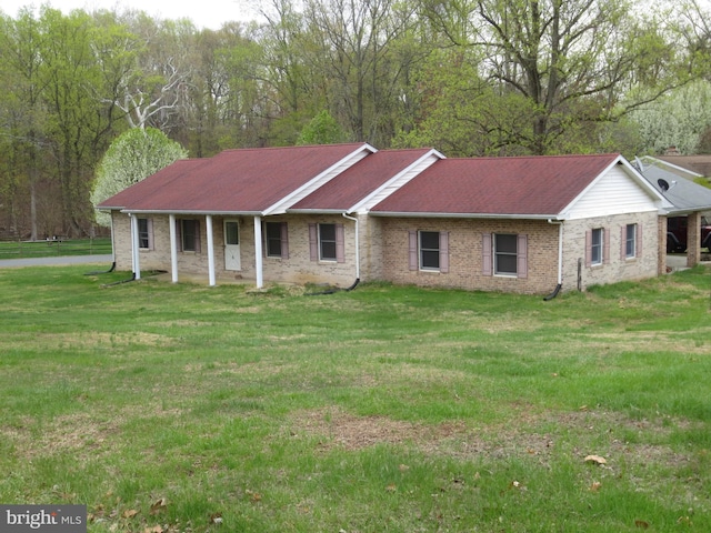 ranch-style home with a front lawn and brick siding