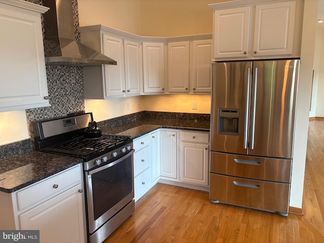 29 Salt Grass Rd, Ocean Pines, MD 21811 - kitchen featuring stainless steel appliances, wall chimney exhaust hood, light wood-type flooring, and white cabinets