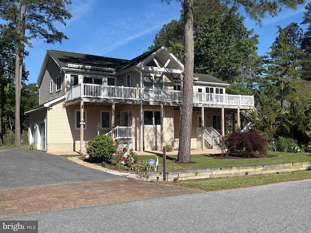 29 Salt Grass Rd, Ocean Pines, MD 21811 - townhome / multi-family property featuring asphalt driveway, a wooden deck, and a garage