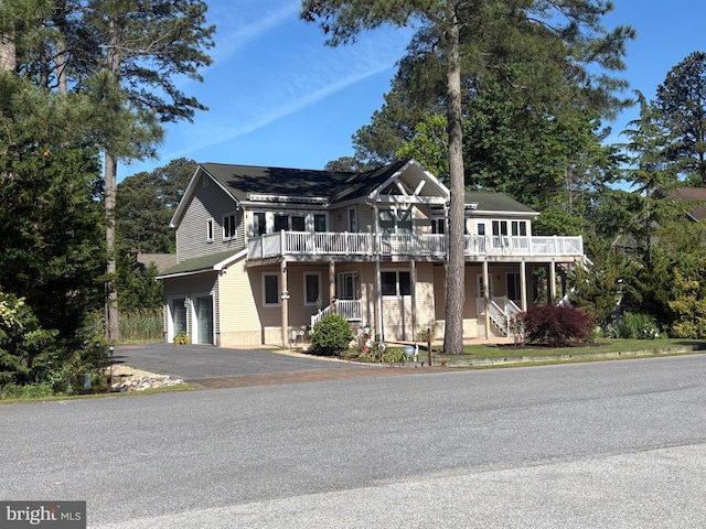 29 Salt Grass Rd, Ocean Pines, MD 21811 - view of front facade with asphalt driveway, a garage, a balcony, and covered porch