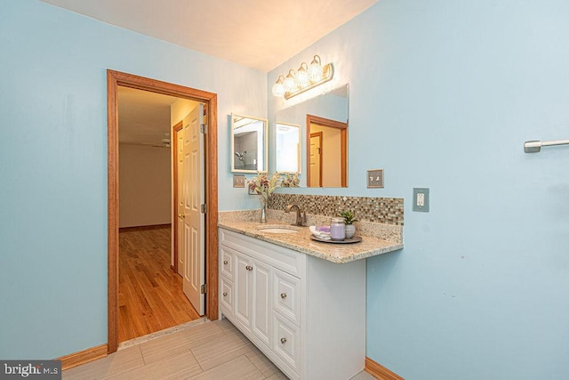 29 Salt Grass Rd, Ocean Pines, MD 21811 - bathroom with vanity, baseboards, wood finished floors, and decorative backsplash